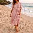 Women's linen beach dress by FJØRNA featuring a casual V-neck, loose fit, midi length, perfect for summer beachwear.