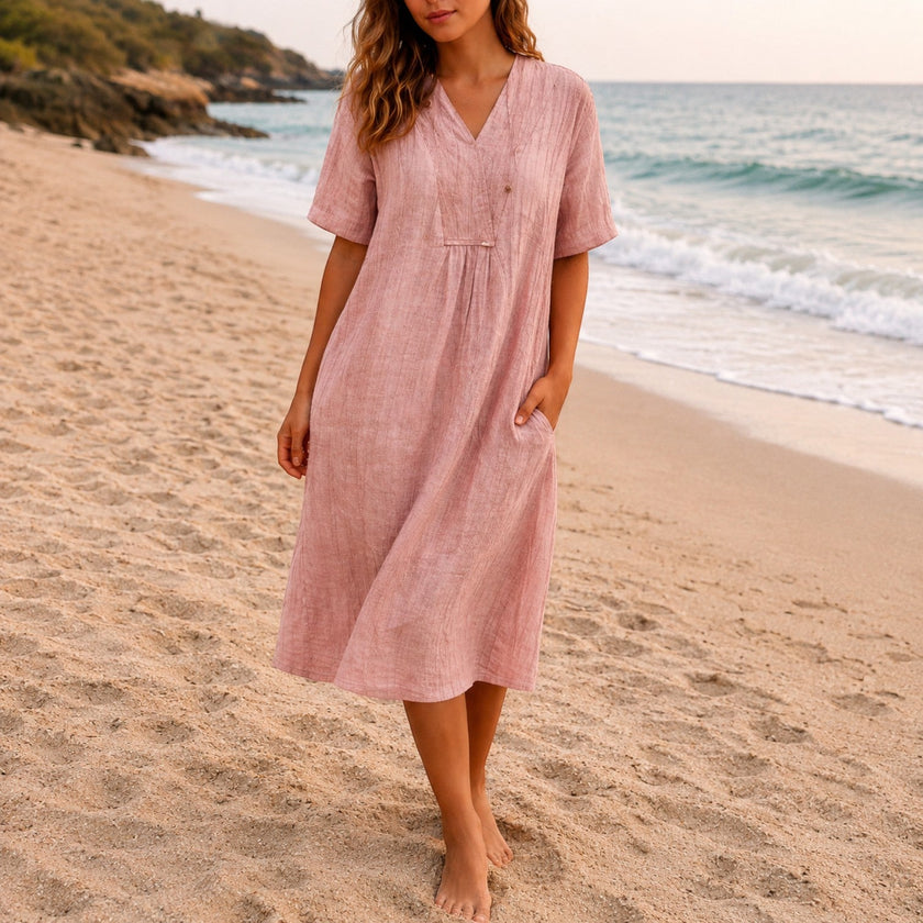 Women's linen beach dress by FJØRNA featuring a casual V-neck, loose fit, midi length, perfect for summer beachwear.