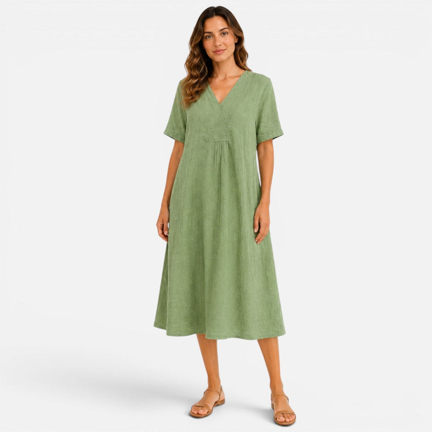 Women's linen beach dress by FJØRNA with a casual V-neck design, loose fit, midi length, perfect for summer outings.
