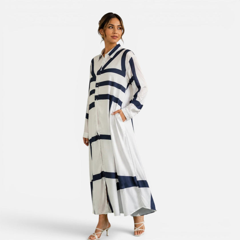 Women's oversized maxi dress by FJØRNA featuring a geometric print and loose fit, styled as a comfortable and elegant dress.