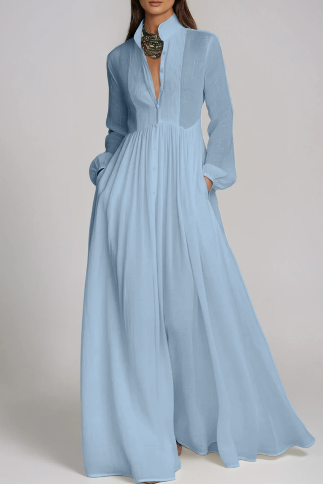 Light blue FJØRNA Fizza plunge ruch maxi dress displayed on a model, featuring flowing fabric and elegant design.