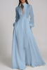 Light blue FJØRNA Fizza plunge ruch maxi dress displayed on a model, featuring flowing fabric and elegant design.