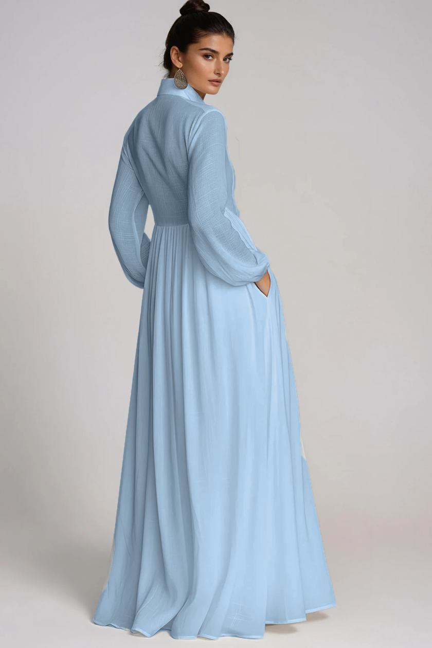 Light blue FJØRNA Fizza Plunge Ruch Maxi Dress featuring a flowing silhouette and elegant ruching detail.