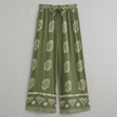 Flat-lay of FJØRNA women's summer cotton wide-leg trousers, showcasing their relaxed fit and lightweight fabric for warm weather.