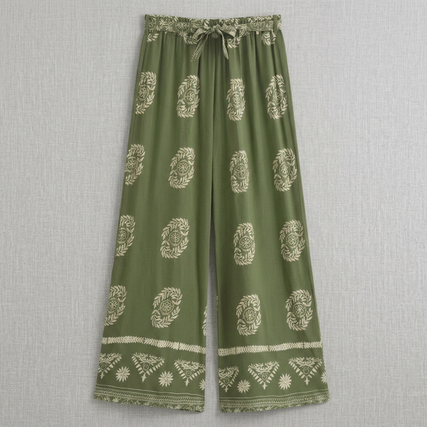 Flat-lay of FJØRNA women's summer cotton wide-leg trousers, showcasing their relaxed fit and lightweight fabric for warm weather.