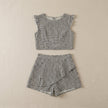 FJØRNA sleeveless ruffle top and tiered shorts set with geometric print, displayed flat on a surface.