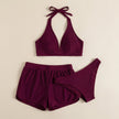 FJØRNA women's summer bikini with halter neck and ruched design, flat lay showing the stylish swimwear in vibrant colors.