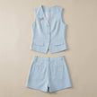 FJØRNA summer women's two-piece set with pockets, V-neck top and matching shorts, laid flat on a neutral background.