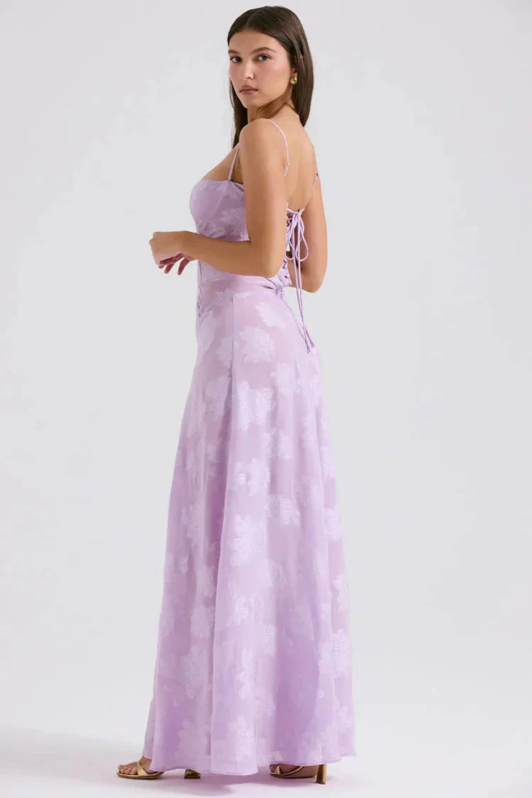 White floral lace-up maxi dress by FJØRNA featuring a flowing silhouette and intricate floral lace details.