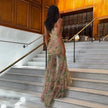 Floral ruched women's maxi dress by FJØRNA featuring a flowing silhouette and vibrant summer floral pattern.