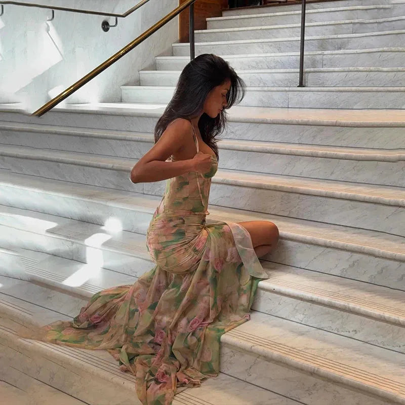 Floral ruched women's maxi dress by FJØRNA, perfect for summer and special occasions, featuring a flowy silhouette and vibrant floral pattern.