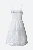 White floral ruffled mini dress by FJØRNA, featuring delicate ruffles and a feminine silhouette, shown on a model.