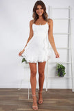 White floral ruffled mini dress by FJØRNA, featuring delicate fabric and feminine ruffle details, perfect for summer wear.