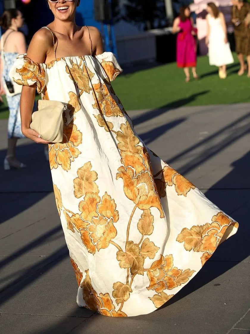 FJØRNA women's floral print sling dress shown in a mini length with colorful flower patterns on lightweight fabric.