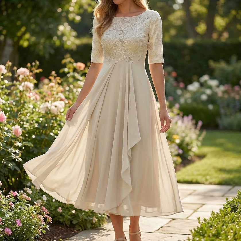 White A-line midi dress with lace bodice by FJØRNA, featuring a flowing skirt and elegant lace detailing.