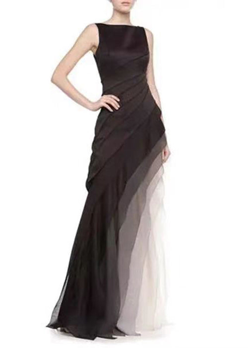 Black high-waist patchwork tulle maxi dress by FJØRNA, sleeveless design with elegant flowing fabric and intricate patchwork details.