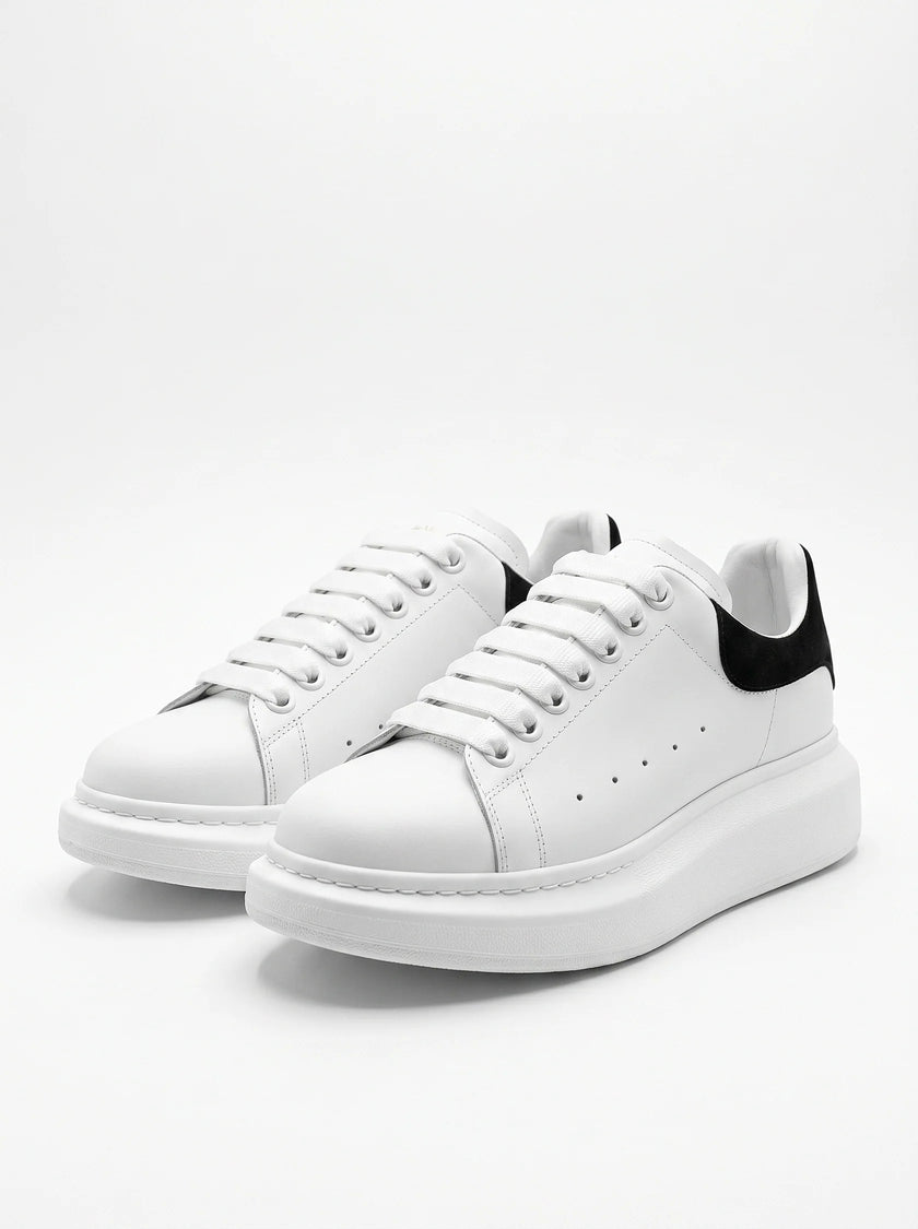 White FJØRNA men's lace-up trainers with minimalist design, ideal for everyday wear, shown from the front view.
