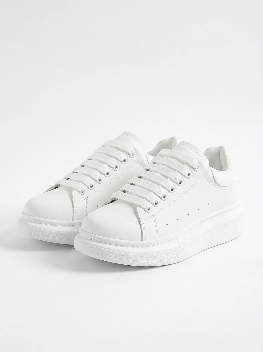 White lace-up men's trainers by FJØRNA, minimalist design, perfect for everyday casual wear, front view of the shoes.