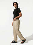 Men's linen trousers by FJØRNA, relaxed fit breathable summer pants shown full body in natural fabric and casual style.