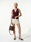 FJØRNA women's sleeveless structured waistcoat, tailored layering piece, full-body view showcasing fit and style.