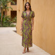FJØRNA A-line wrap front maxi dress with V-neck, full-body view showcasing elegant flowy fabric and stylish design.