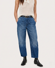 FJØRNA women's denim jeans with a relaxed barrel leg fit, showcasing classic blue denim and stylish, comfortable design.