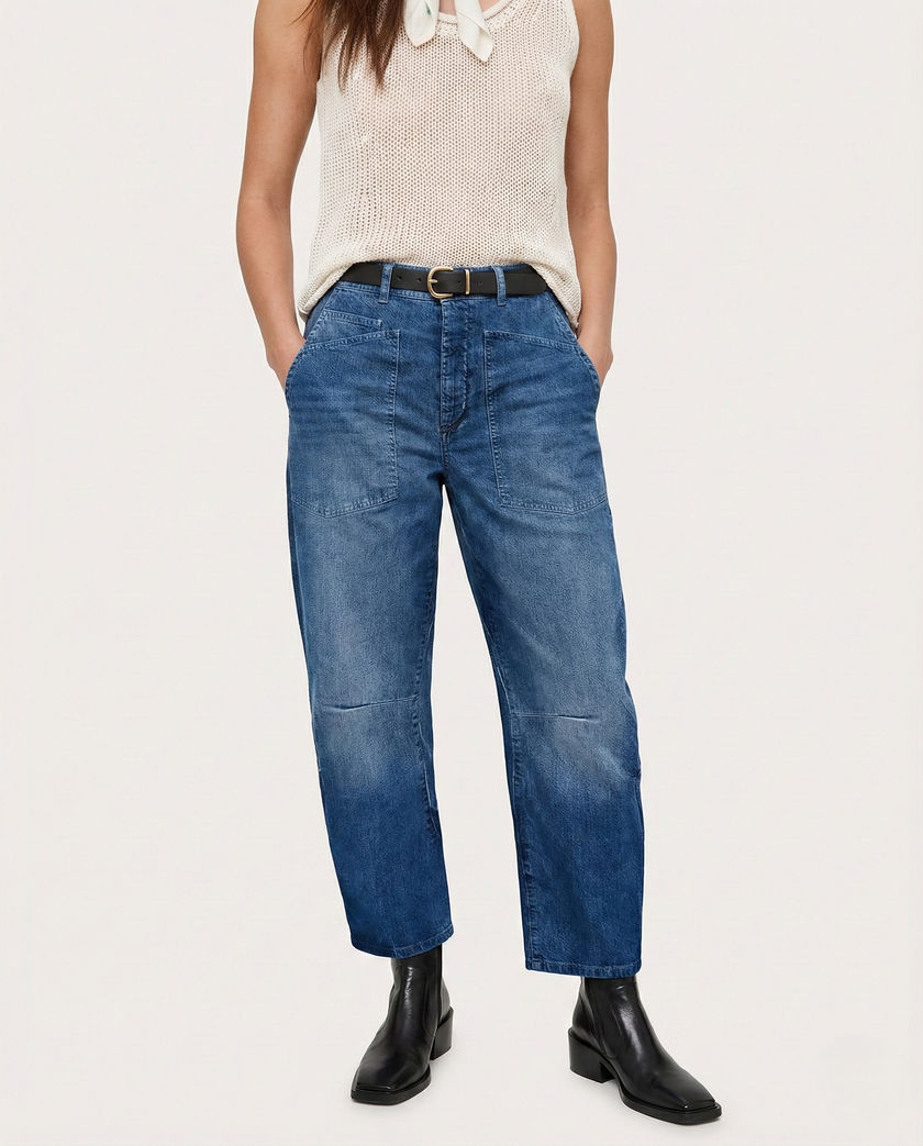 FJØRNA women's denim jeans with a relaxed barrel leg fit, showcasing classic blue denim and stylish, comfortable design.