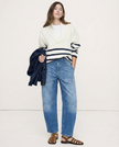 Women’s denim jeans with a barrel leg fit from FJØRNA, showcasing classic blue denim and relaxed, modern style.