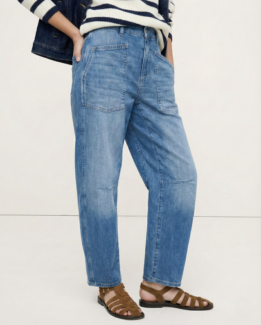 FJØRNA women's denim jeans with barrel leg style, showcasing classic blue pants with a relaxed fit and stylish design.