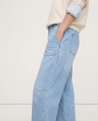 FJØRNA women's denim barrel leg jeans, stylish pants with a relaxed fit and classic blue wash, displayed on a model.