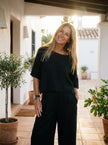 FJØRNA relaxed linen-texture two-piece set with wide-leg trousers, featuring a casual, comfortable fit in natural fabric.