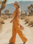 FJØRNA mustard cotton linen sleeveless boho jumpsuit for women, showing its relaxed fit and stylish design.