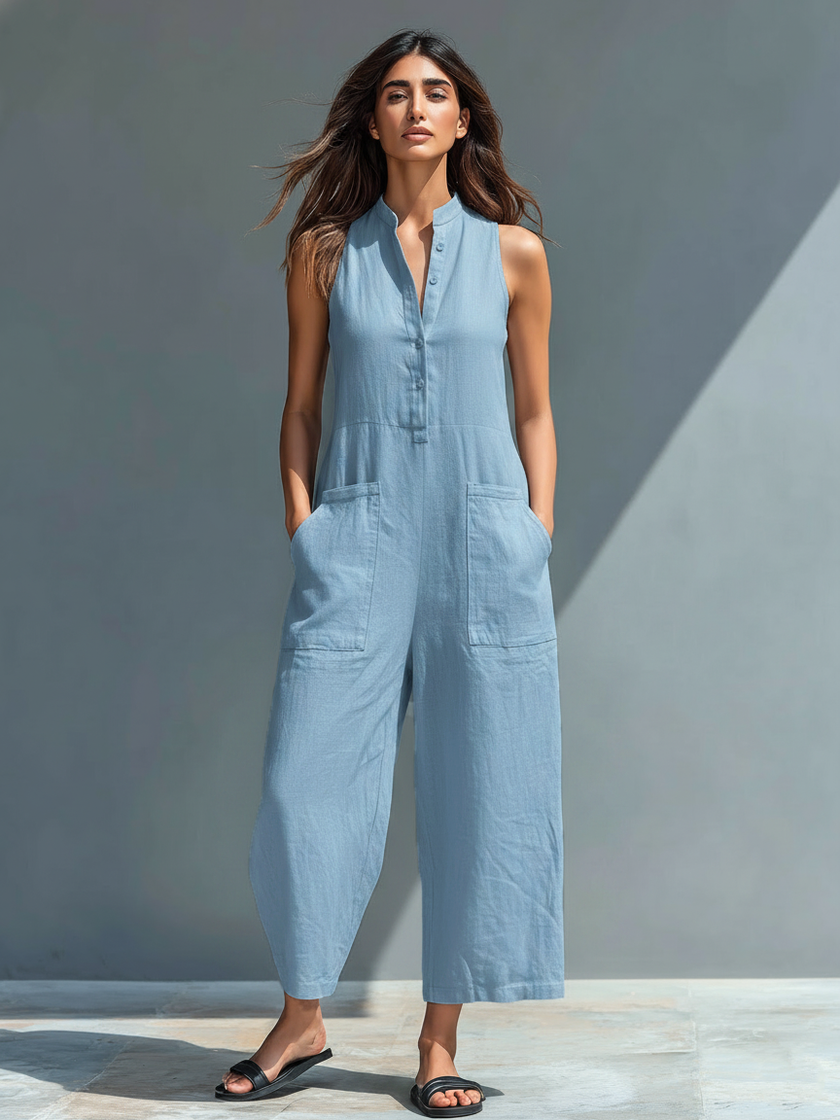 FJØRNA linen blend sleeveless women's jumpsuit with stand collar, button-up front, and loose fit, shown on a model.