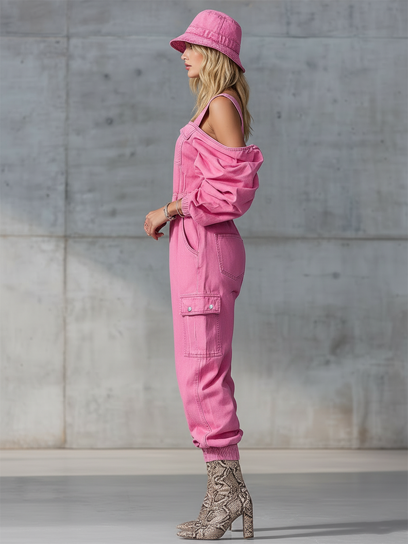 Pink denim FJØRNA jumpsuit with strappy details and tapered long sleeves, shown on a model.