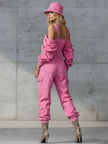Pink denim strappy tapered long sleeve jumpsuit by FJØRNA, featuring a fitted silhouette and stylish design.