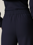 Navy FJØRNA double-breasted two-piece suit set with lapel collar, tailored fit, and matching trousers on a hanger.
