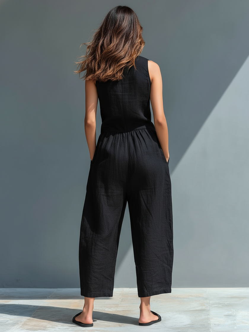FJØRNA linen blend sleeveless women's jumpsuit with stand collar, button-up front, and loose fit, styled as pants.