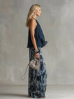 Navy blue printed wide-leg FJØRNA women's pants with a relaxed fit and flowing fabric, stylishly draped on a model.