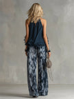 Women's navy blue printed wide-leg trousers from FJØRNA, featuring a relaxed fit and stylish pattern.
