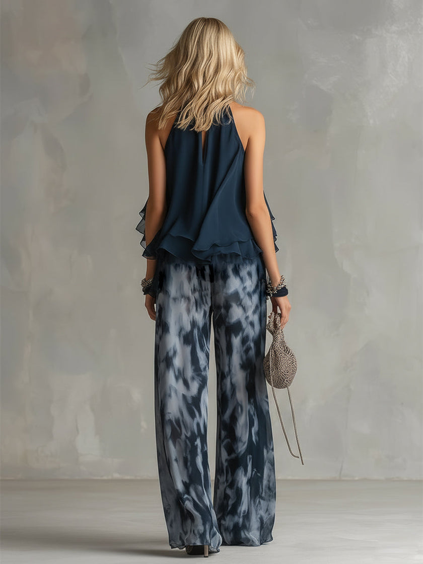 Women's navy blue printed wide-leg trousers from FJØRNA, featuring a relaxed fit and stylish pattern.