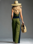 Green FJØRNA sleeveless jumpsuit with stand collar and front zipper, displayed on a model.