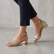 Gold orthopedic metallic block heel ankle strap sandals for women by FJØRNA, featuring a stylish ankle strap and comfortable heel.