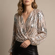 Gold V-neck long sleeve sequin blouse for women by FJØRNA, featuring a stylish summer top with shimmering details.
