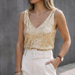 Gold sequin sleeveless women's top by FJØRNA with a V-neck and all-over embellishments, featuring a shiny, eye-catching design.