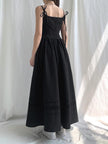 White Goth Strap Maxi Dress by FJØRNA, featuring a stylish maxi length and edgy strap details, worn in a studio setting.