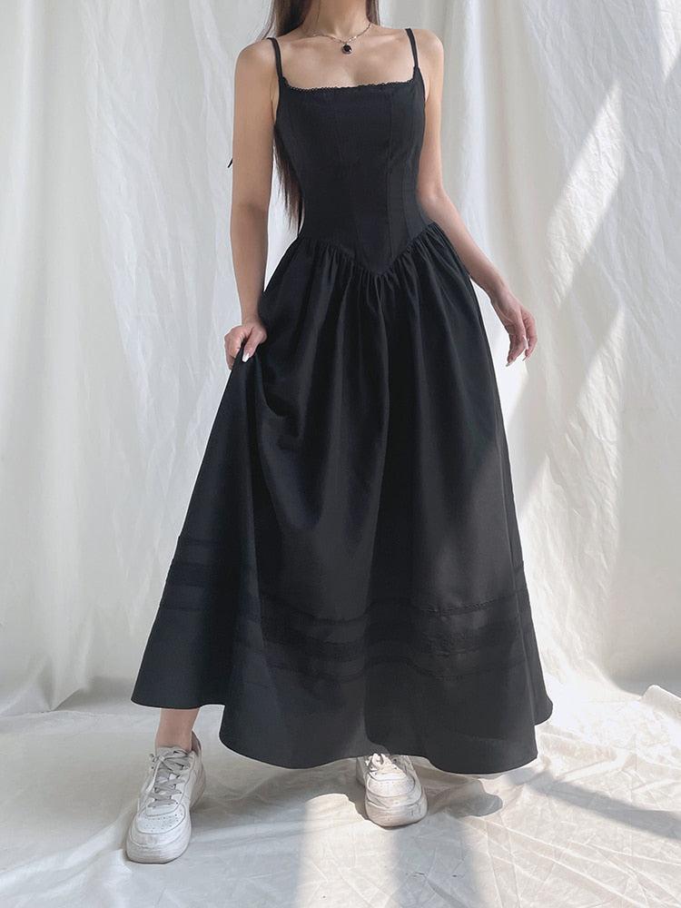 White Goth strap maxi dress by FJØRNA featuring a fitted silhouette and stylish strap details, ideal for edgy, modern fashion.