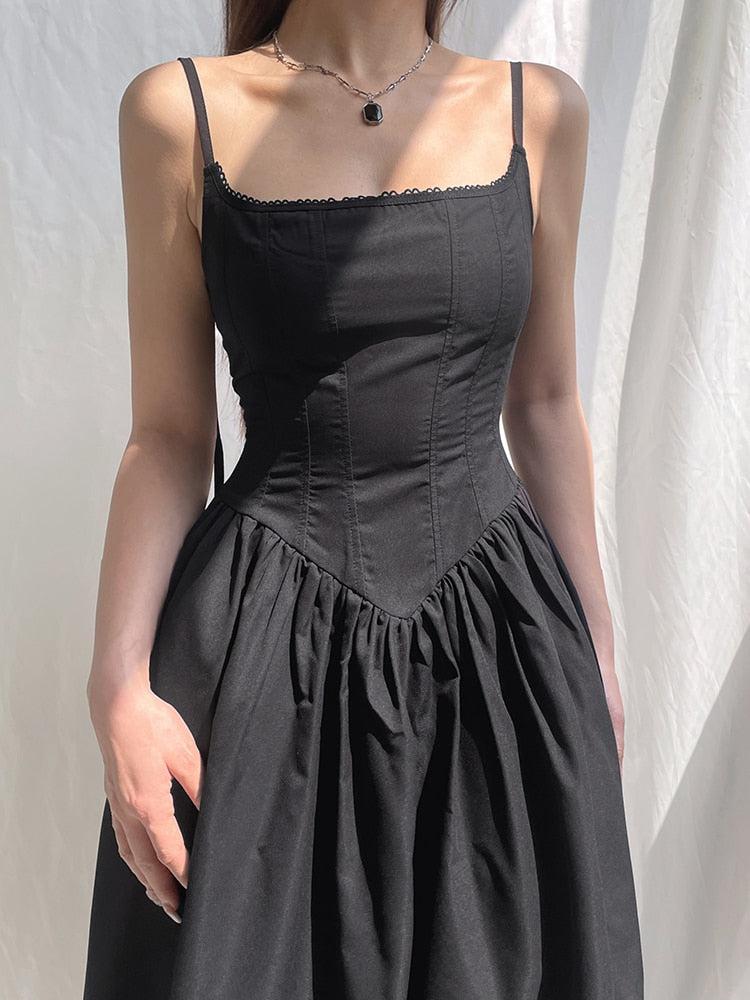 White goth strap maxi dress by FJØRNA, featuring a flowing silhouette and stylish strap details, perfect for edgy fashion looks.