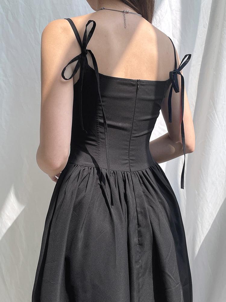 White Goth Strap Maxi Dress by FJØRNA, featuring a fitted bodice and flowing skirt with gothic strap details.