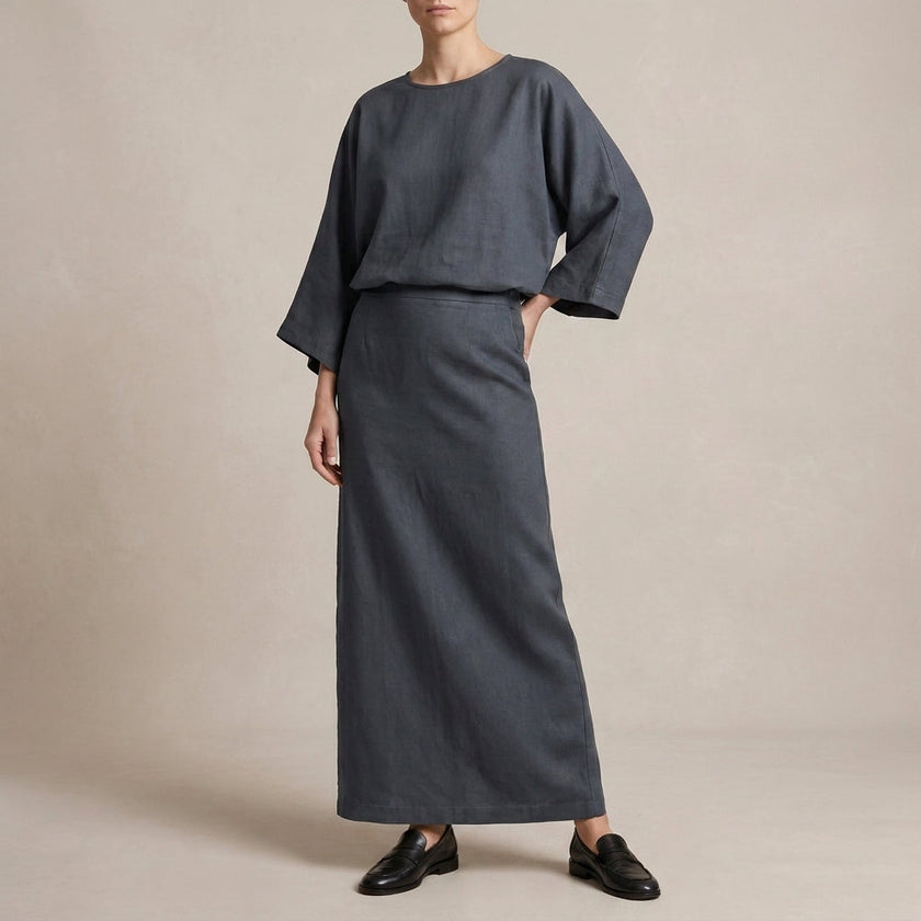 FJØRNA two-piece textured woven skirt suit with draped high-waist silhouette in graphite, featuring elegant, tailored design.