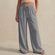 Gray women's linen trousers with drawstring waist and pockets, stylish summer clothing by FJØRNA.